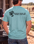 The Brand Tee in Heathered Eucalyptus Blue — male model, back view
