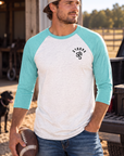 The Brand Baseball Tee in Tahiti Blue/Heather White — male model, front view