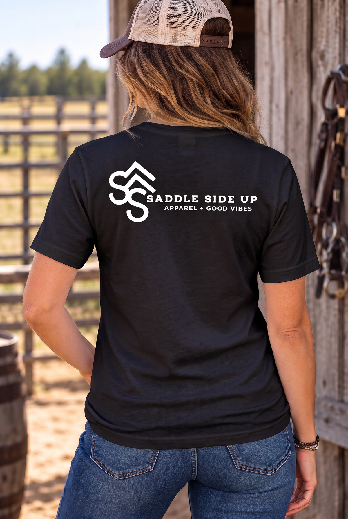The Brand Tee in Black — female model, back view