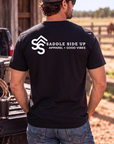 The Brand Tee in Black — male model, back view
