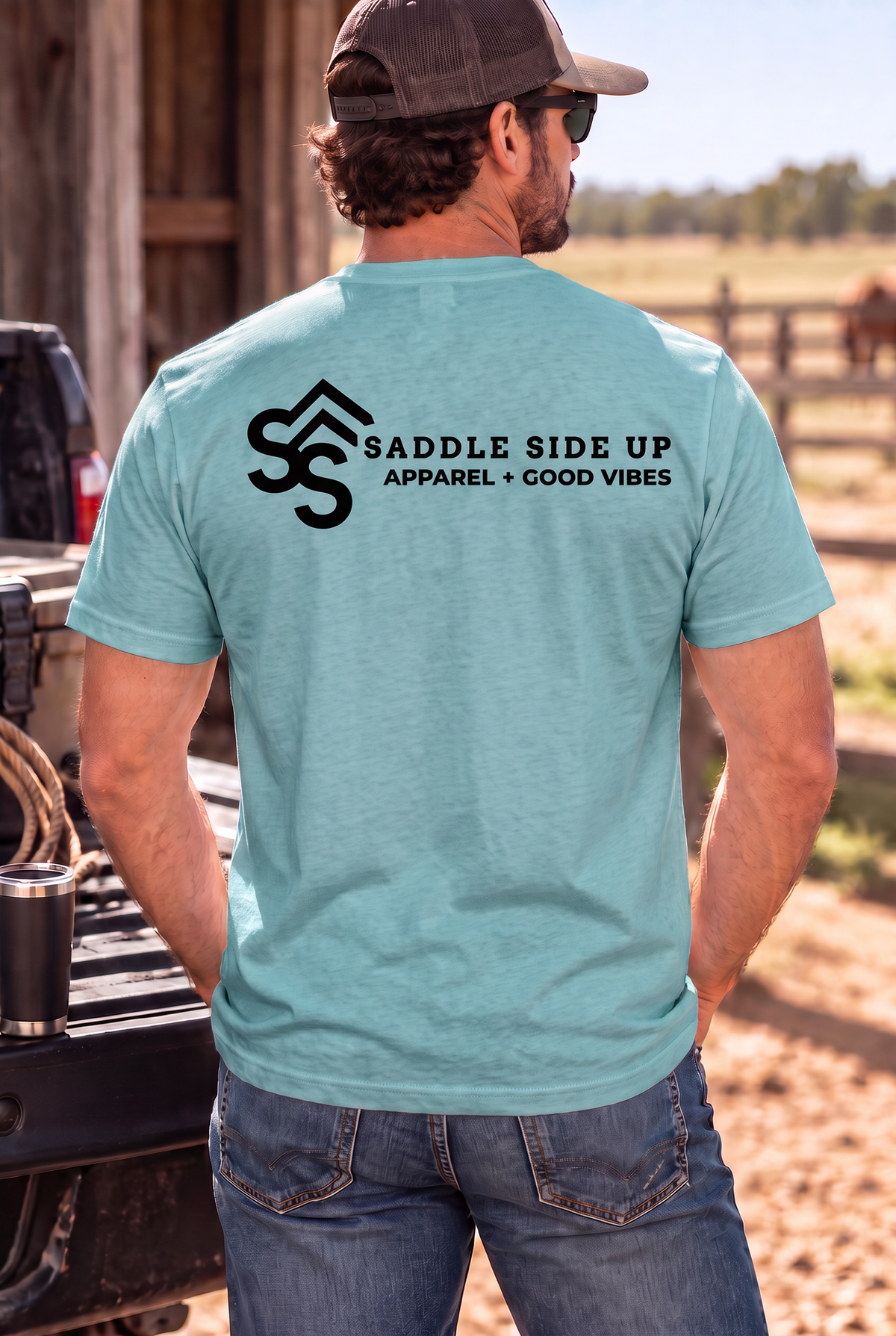 The Brand Tee in Heathered Eucalyptus Blue — male model, back view