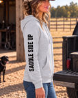The Branded Zip in Light Heather Grey — female model, side view showing SADDLE SIDE UP sleeve print