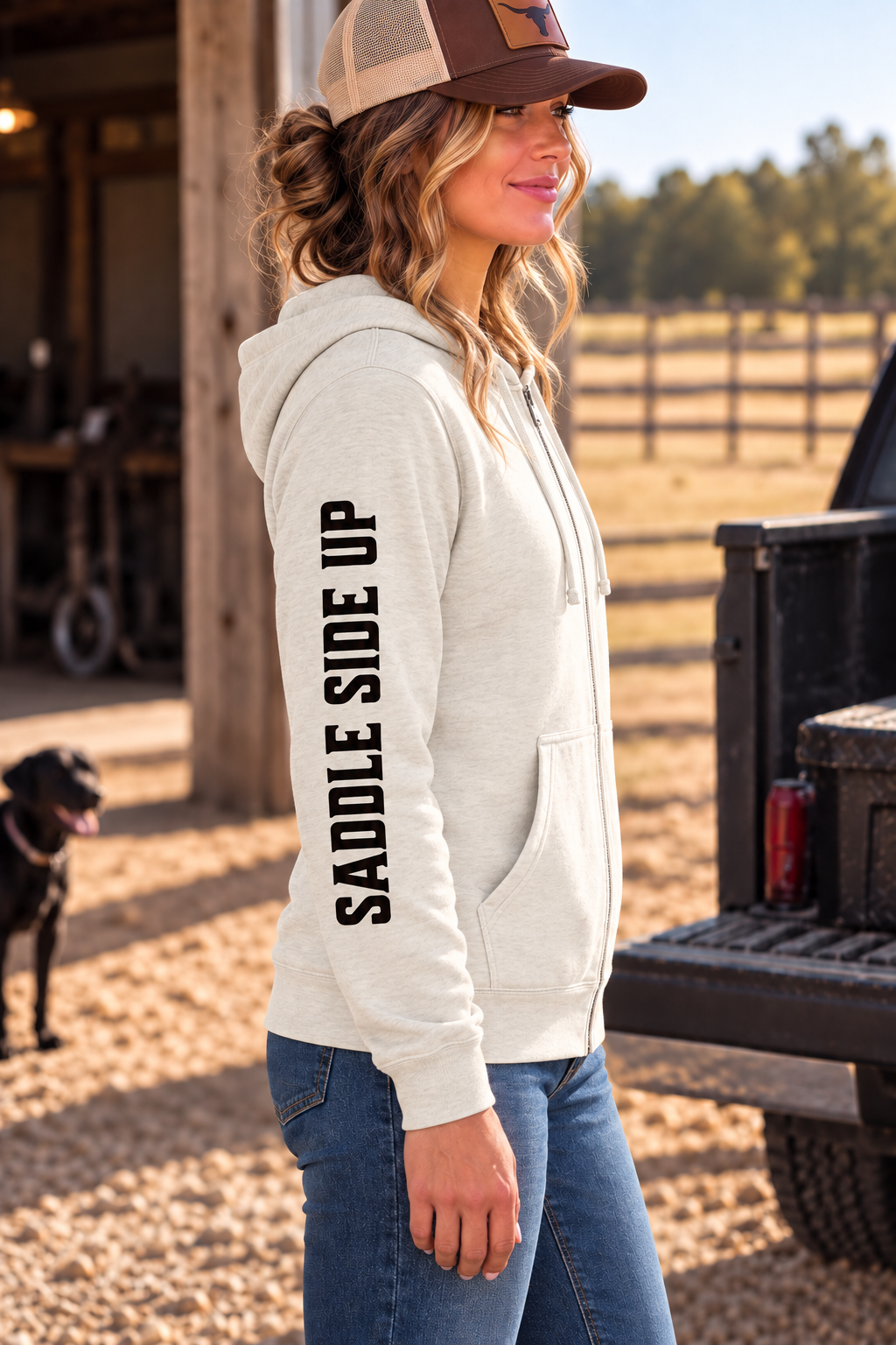 The Branded Zip in Oatmeal Heather — female model, side view showing SADDLE SIDE UP sleeve print