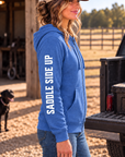 The Branded Zip in Royal Frost — female model, side view showing SADDLE SIDE UP sleeve print